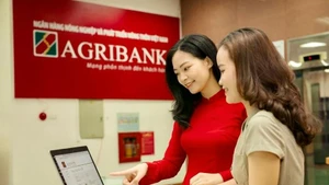 越南农业与农村发展银行（Agribank）工作人员引导客户在数字化渠道进行安全交易。（图片来源：人民军报）