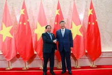 越南政府总理范明正会见中共中央总书记、中国国家主席习近平。（图片来源：VGP）