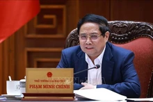 范明正总理主持召开政府常务委员会与各部委和地方会议。（图片来源：越通社）