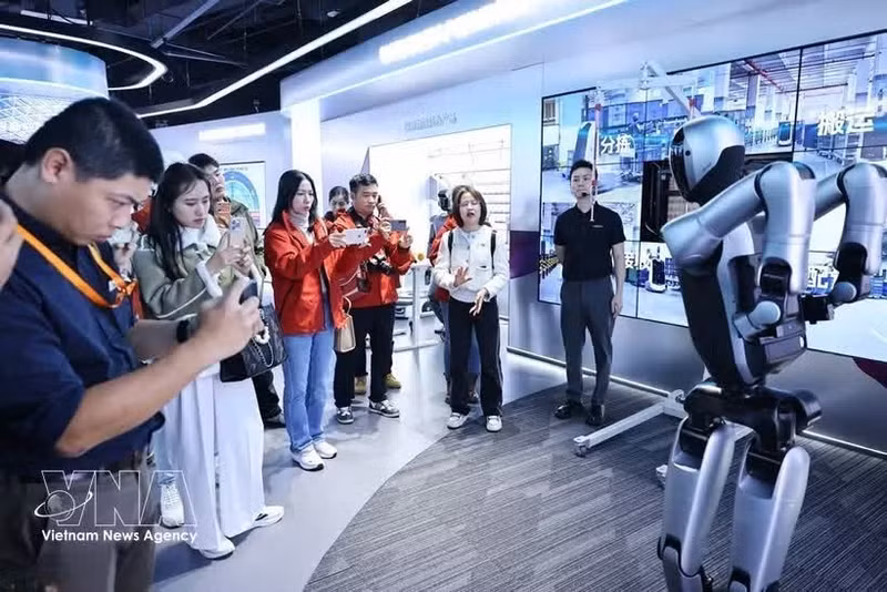 代表参观了解UBTECH公司人形机器人研发情况。（图片来源：越通社）