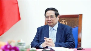 越南政府总理范明正与卡塔尔首相兼外交大臣通电话。（图片来源：VGP）