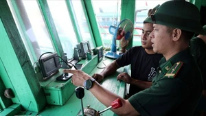 岘港市边防部队指挥部山茶边防站的干部、战士对渔民的渔船通信联络设备进行检查。（图片来源：越通社）