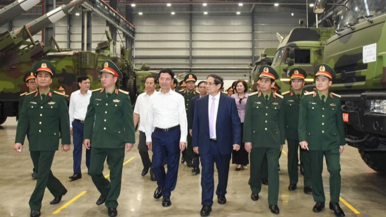 范明正总理视察越南电信集团研发生产的部分国防工业产品。（陈海 摄）