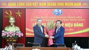 苏林总书记向潘廷镯同志颁发45年党龄纪念章。（登科 摄）