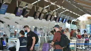 游客在泰国曼谷素万那普国际机场办理登机手续。（图片来源：新华社/越通社）