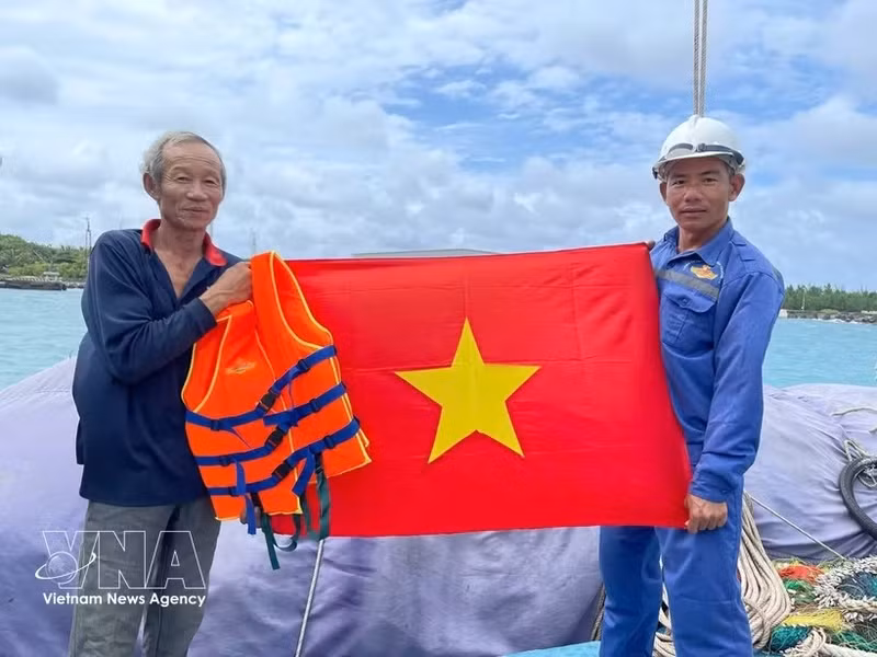 海军力量向渔民赠送国旗。