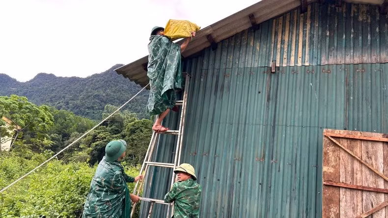 伽向边防哨所的干部和战士帮助明化县上化乡的人民在屋顶上放置沙袋,以防止强风和暴风雨掀翻屋顶。 伽向边防哨所的干部和战士帮助明化县上化乡的人民在屋顶上放置沙袋,以防止强风和暴风雨掀翻屋顶。