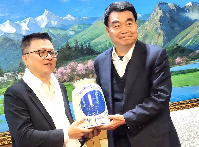 黎国明同志向汪海洲同志赠送礼品。