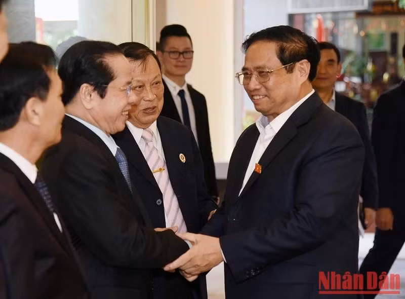 范明正总理与越南老战士协会常委会成员一一握手。