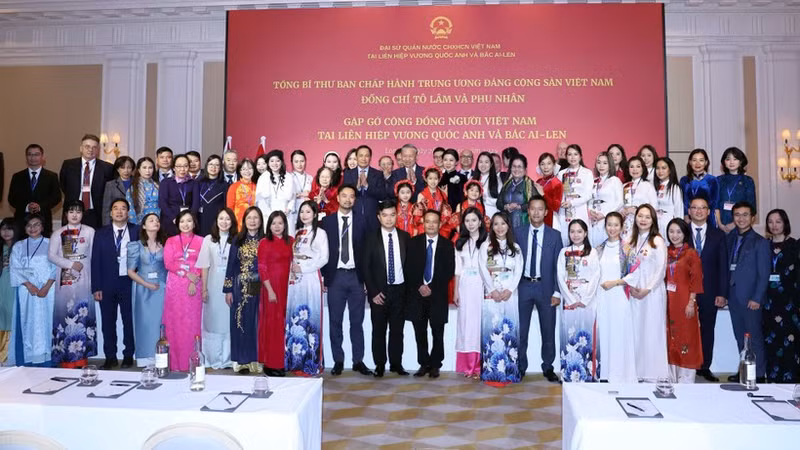 苏林总书记和夫人与旅居英国越侨代表合影。（图片来源：越通社）